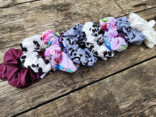 Load image into Gallery viewer, collection of scrunchies on wood surface
