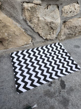 Load image into Gallery viewer, A white chevron patterned cotton pouch with a zipper, placed on a stone surface.