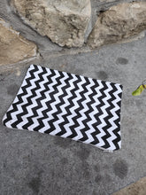 Load image into Gallery viewer, A white chevron patterned cotton pouch with a zipper, placed on a stone surface.