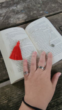 Load image into Gallery viewer, silver chain bookmark with red tassel on top of a book