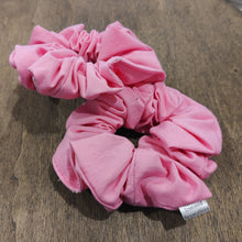 Load image into Gallery viewer, two light pink scrunchies on a wood surface