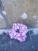 Load image into Gallery viewer, A pink and white pattern cotton scrunchie hair accessory, displayed against a stone surface with snow on the ground.