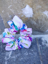 Load image into Gallery viewer, light purple scrunchie with multicoloured floral design on stone surface