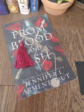 Load image into Gallery viewer, silver chain bookmark with burgundy tassel on top of a book