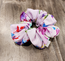 Load image into Gallery viewer, light purple scrunchie with multicoloured floral design on wooden surface