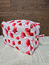 Load image into Gallery viewer, side view of cosmetic bag abstract red and pink poppy flower with black stem on white back ground with white zipper 
