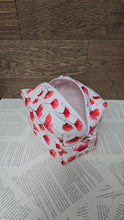 Load image into Gallery viewer, top view of cosmetic bag abstract red and pink poppy flower with black stem on white back ground with white zipper pale pink polka dot inner lining 
